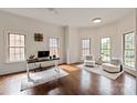 Bright office space with three large windows, hardwood floors and area rugs at 11841 Churchfield Ln, Charlotte, NC 28277