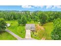 Expansive aerial view showcasing the home's setting amidst lush greenery and mature trees at 124 Vintage Woods Ct, Shelby, NC 28150