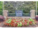 Centennial at Historic Huntersville entrance sign with colorful flowers and lush greenery at 14904 Rosemary Way Dr, Huntersville, NC 28078