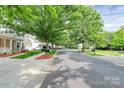 Inviting neighborhood street view with sidewalks and well-maintained homes, perfect for leisurely strolls and community charm at 14904 Rosemary Way Dr, Huntersville, NC 28078