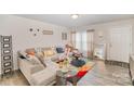 Inviting living room with neutral colors, wood-look flooring, and a comfortable sectional sofa at 152 Grassy Meadow Ln, Statesville, NC 28625