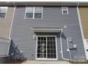 Exterior view of the rear of the house featuring gray siding and sliding glass doors to the backyard at 15239 Wrights Crossing Dr, Charlotte, NC 28278