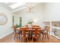 Elegant dining room with skylight, modern chandelier, and seating for six, creating a perfect space for entertaining guests at 1601 Wandering Way Dr, Charlotte, NC 28226