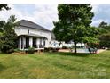 Expansive backyard featuring a swimming pool, patio area, screened porch, and lush landscaping at 19625 Callaway Hills Ln, Davidson, NC 28036