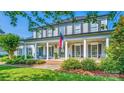 Stately two-story home with a grand front porch, classic columns, and professionally landscaped front yard at 19625 Callaway Hills Ln, Davidson, NC 28036