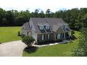Beautiful home showcasing brick and siding exterior, manicured lawn, and attached garage at 2018 Whiskery Ct, York, SC 29745