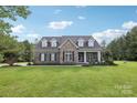Charming home with brick facade, dormer windows, black shutters, and well-kept lawn at 2018 Whiskery Ct, York, SC 29745