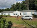 Charming single-story home with light siding, blue shutters, and a well-maintained front yard at 2194 Sterling Ridge Dr, Newton, NC 28658