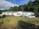 Charming single-story home with light siding, blue shutters, and a well-maintained front yard at 2194 Sterling Ridge Dr, Newton, NC 28658