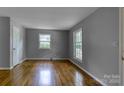 This bedroom features hardwood floors, neutral gray walls, and plenty of natural light from the double hung windows at 24 19Th Nw St, Hickory, NC 28601