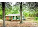 Quaint single-story home with brick and siding facade and lush greenery surrounding the property at 24 19Th Nw St, Hickory, NC 28601