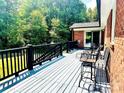 Inviting outdoor deck with dark railing and comfortable seating for relaxing and enjoying backyard view at 2405 Forrestbrook Dr, Kannapolis, NC 28083