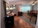 Welcoming entryway with hardwood flooring, decorative mirror, and view to dining area at 2405 Forrestbrook Dr, Kannapolis, NC 28083