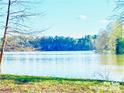 Picturesque lake view showing trees and blue sky with some small clouds on a sunny day at 2405 Forrestbrook Dr, Kannapolis, NC 28083