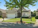 Beautiful single-story home with stone accents, well-maintained lawn, landscaping, and attached two-car garage at 26444 Sandpiper Ct, Fort Mill, SC 29707