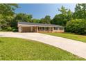 Well-maintained brick ranch with a long driveway leading to a convenient covered carport and front entry at 279 Bailey Rd, Lancaster, SC 29720