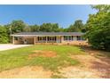 Well-kept brick home featuring a covered front porch and spacious front yard at 279 Bailey Rd, Lancaster, SC 29720