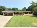 Charming brick ranch-style home with a well-maintained lawn, a covered carport and inviting curb appeal at 279 Bailey Rd, Lancaster, SC 29720