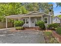 Inviting gray home featuring a covered parking area, brick walkway, and front yard shrubbery at 2813 Hilliard Dr, Charlotte, NC 28205