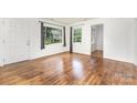 Hardwood floors, white walls, and natural light make this living room a cozy, relaxing space at 2819 Georgia Ave, Charlotte, NC 28205