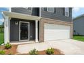 Inviting front entrance with a covered porch and a direct access to the attached two-car garage at 3025 Ora Smith Rd, Lincolnton, NC 28092