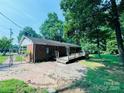 Brick home with a wooden deck and a brick patio in a partially shaded backyard at 316 Meadowood Cir, Kannapolis, NC 28081
