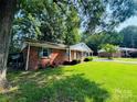 Brick house featuring a well-manicured lawn and established landscaping at 316 Meadowood Cir, Kannapolis, NC 28081