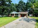 Quaint brick home with a carport and well-maintained front yard at 316 Meadowood Cir, Kannapolis, NC 28081