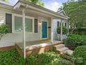 Inviting covered porch with a bright blue door, offering a warm welcome to the home at 3339 Benard Ave, Charlotte, NC 28206