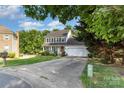 Two-story home with a two-car garage and a well-manicured lawn at 3505 Mallard Cove Ct, Charlotte, NC 28269