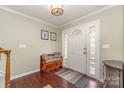 Inviting foyer with hardwood floors, a bench, and natural light from the front door at 3505 Mallard Cove Ct, Charlotte, NC 28269