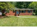 Classic brick home with a neat front yard and inviting front entrance at 3939 Sheffield Dr, Charlotte, NC 28205