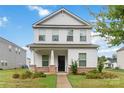 Charming two-story home featuring a covered porch with stone accents and well-manicured landscaping at 422 Nixon Rd, Belmont, NC 28012