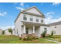 Charming two-story home featuring a covered porch with stone accents and well-manicured landscaping at 422 Nixon Rd, Belmont, NC 28012