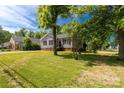 Charming home with gray siding and brick foundation, surrounded by a lush green lawn at 506 Locust St, Rock Hill, SC 29730