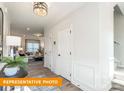 Bright entryway with decorative wainscoting, view to a living room, and a staircase leading upstairs at 530 Hullview Vis, Monroe, NC 28110