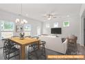 Inviting living and dining area with stylish furniture, ample natural light, and a modern ceiling fan at 6013 Jasmine Branch Rd, Charlotte, NC 28216