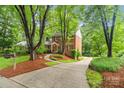 Beautiful brick home with lush landscaping, a curved driveway, and a well-maintained lawn, enhancing its curb appeal at 626 Trail Ridge Rd, Matthews, NC 28105