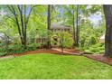 Lovely home surrounded by mature trees and greenery, featuring a manicured lawn and charming front entrance at 626 Trail Ridge Rd, Matthews, NC 28105
