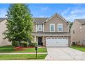 Charming two-story home with a well-maintained lawn and a large tree in the front yard at 6510 Nathan Dr # 78, Charlotte, NC 28269
