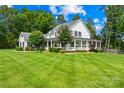 Attractive two-story home with a welcoming wrap-around porch and vibrant green lawn at 738 Rocky Hollow Trl, Clover, SC 29710