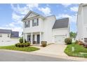 Charming two-story home with a garage, covered porch and a well-manicured lawn at 8005 Stevie Oaks Ln, Charlotte, NC 28215