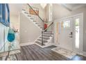 Elegant foyer features a staircase with wrought iron railings, chandelier, and ample natural light at 8418 Knollwood Cir, Charlotte, NC 28213