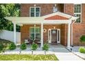 Inviting front porch with decorative wreath, seating area, and meticulously maintained landscaping at 8418 Knollwood Cir, Charlotte, NC 28213