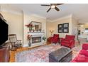 Comfortable living room featuring a fireplace, plush seating, and ceiling fan at 9210 Ginhouse Ln, Charlotte, NC 28277