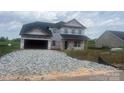 Two-story home featuring an attached two-car garage, covered front porch and a large yard at 1090 Gardenia Dr # 5, Mt Ulla, NC 28125
