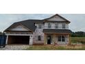 Two-story home featuring an attached two-car garage and classic colonial-style windows at 1090 Gardenia Dr # 5, Mt Ulla, NC 28125