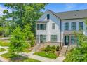 Beautiful three-story townhouse with white siding, black trim, and a well-maintained front yard at 11938 Fiddlers Roof Ln, Charlotte, NC 28277
