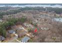 Aerial view of a home situated among mature trees and other houses near a lake at 122 Ardmore Pl, Mooresville, NC 28117