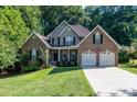 Traditional brick home with an attached two-car garage and a manicured lawn at 122 Ardmore Pl, Mooresville, NC 28117